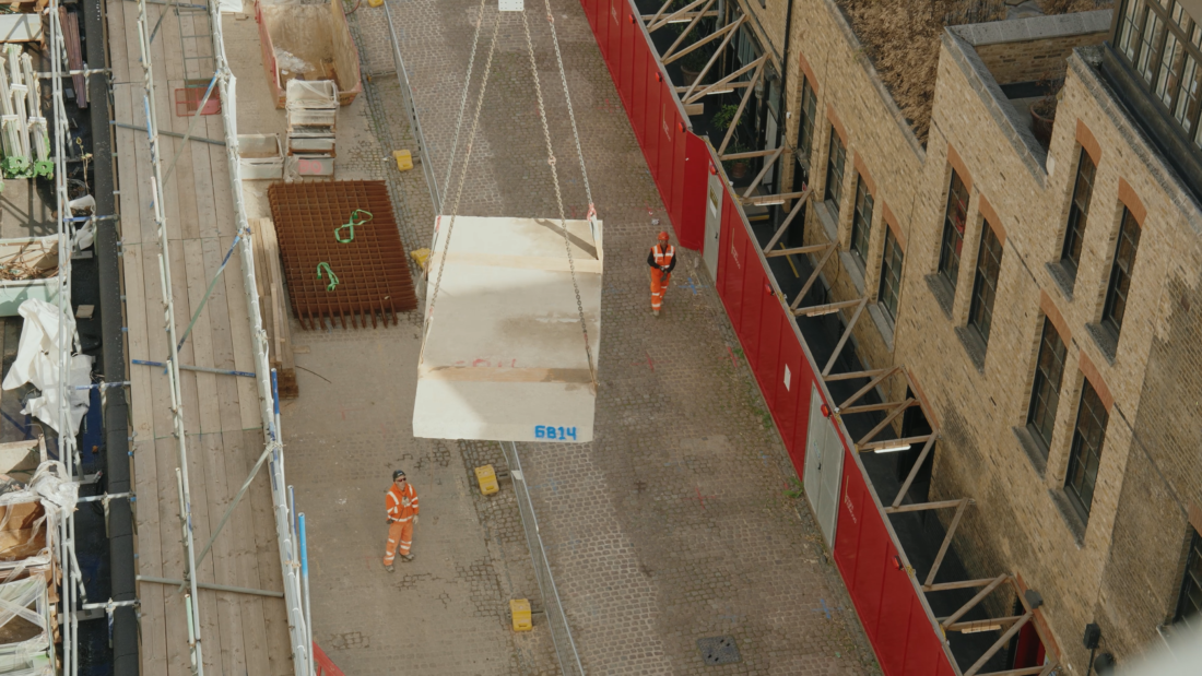 A photo showing a concrete slab being lifted from the site